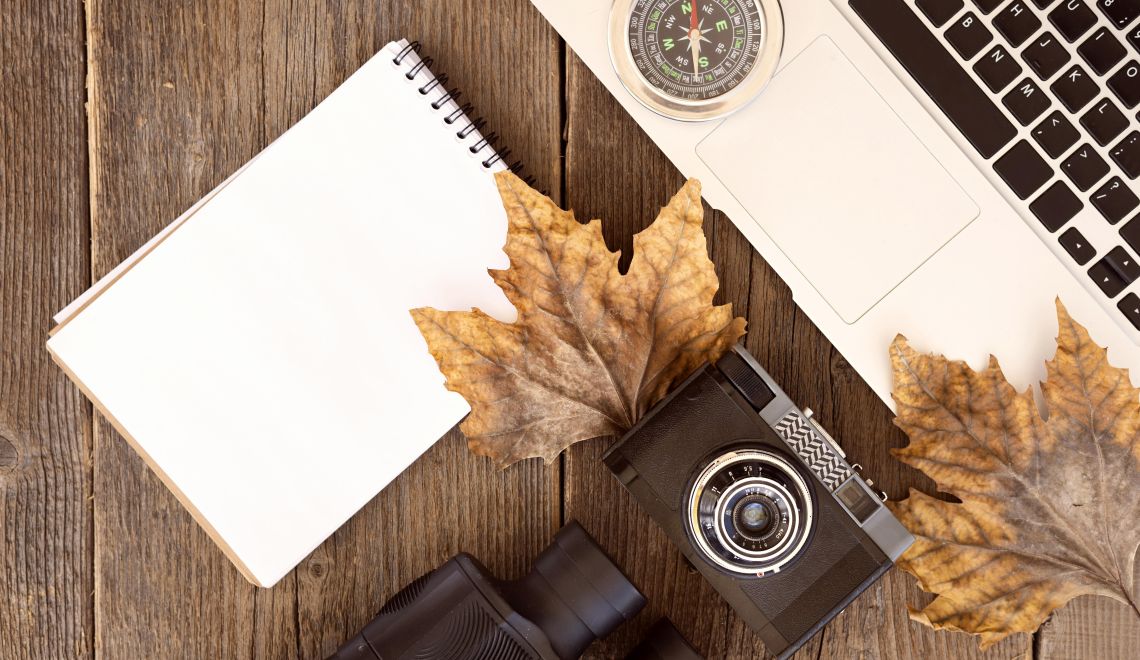 top-view-autumn-adventure-elements-with-empty-notepad
