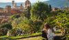 Girl sitting on the grass with a beautiful view of Florence at the background